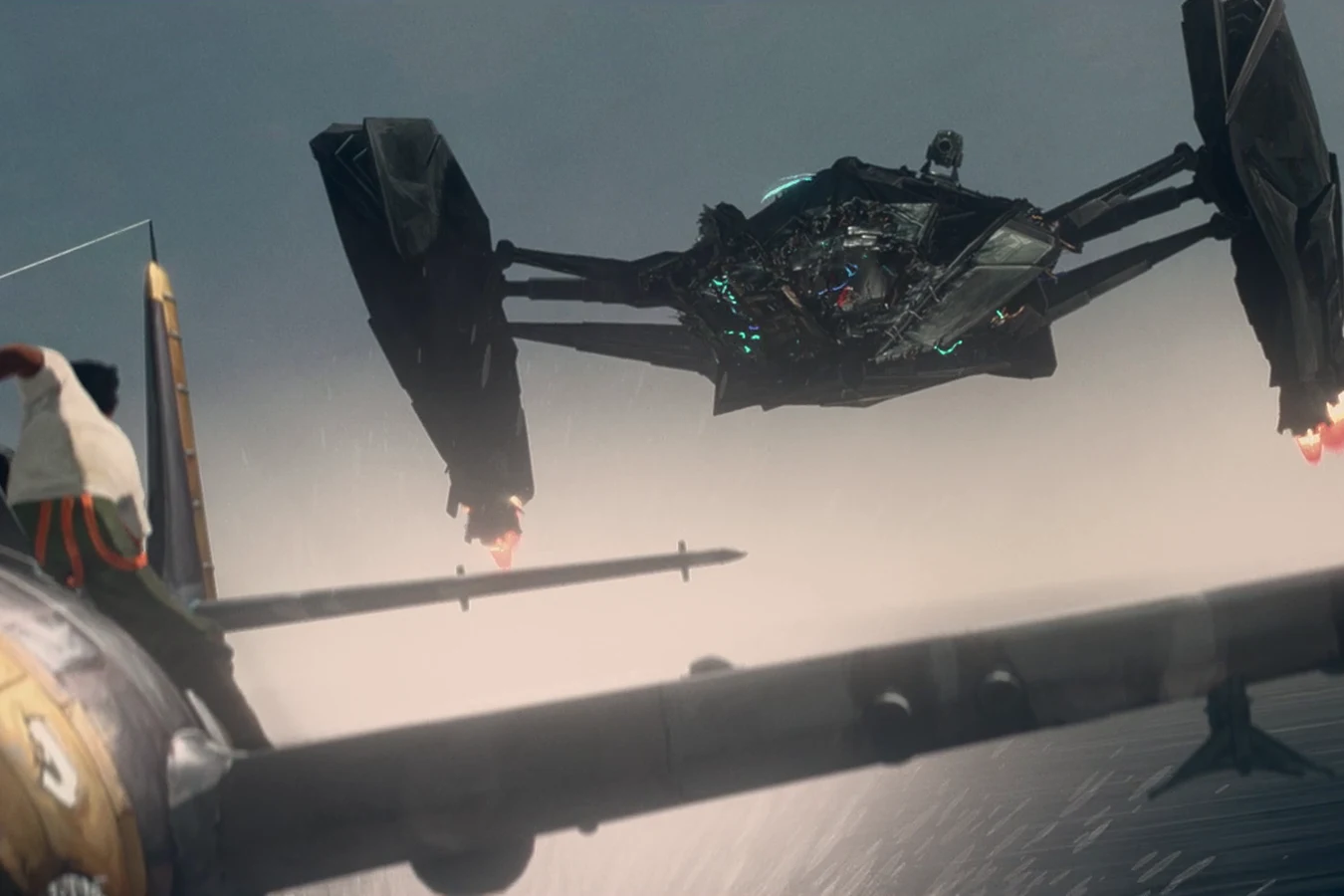 Torres stands on a Wildcat as a Predator fighter closes in over the water