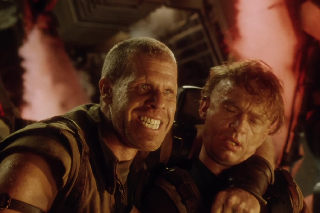 Johner grinning with Vriess strapped to his back as the Betty descended to Earth