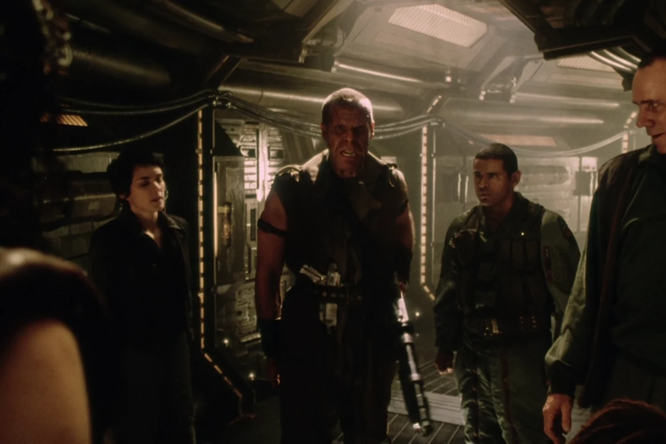 Johner walking an Auriga corridor with the other survivors