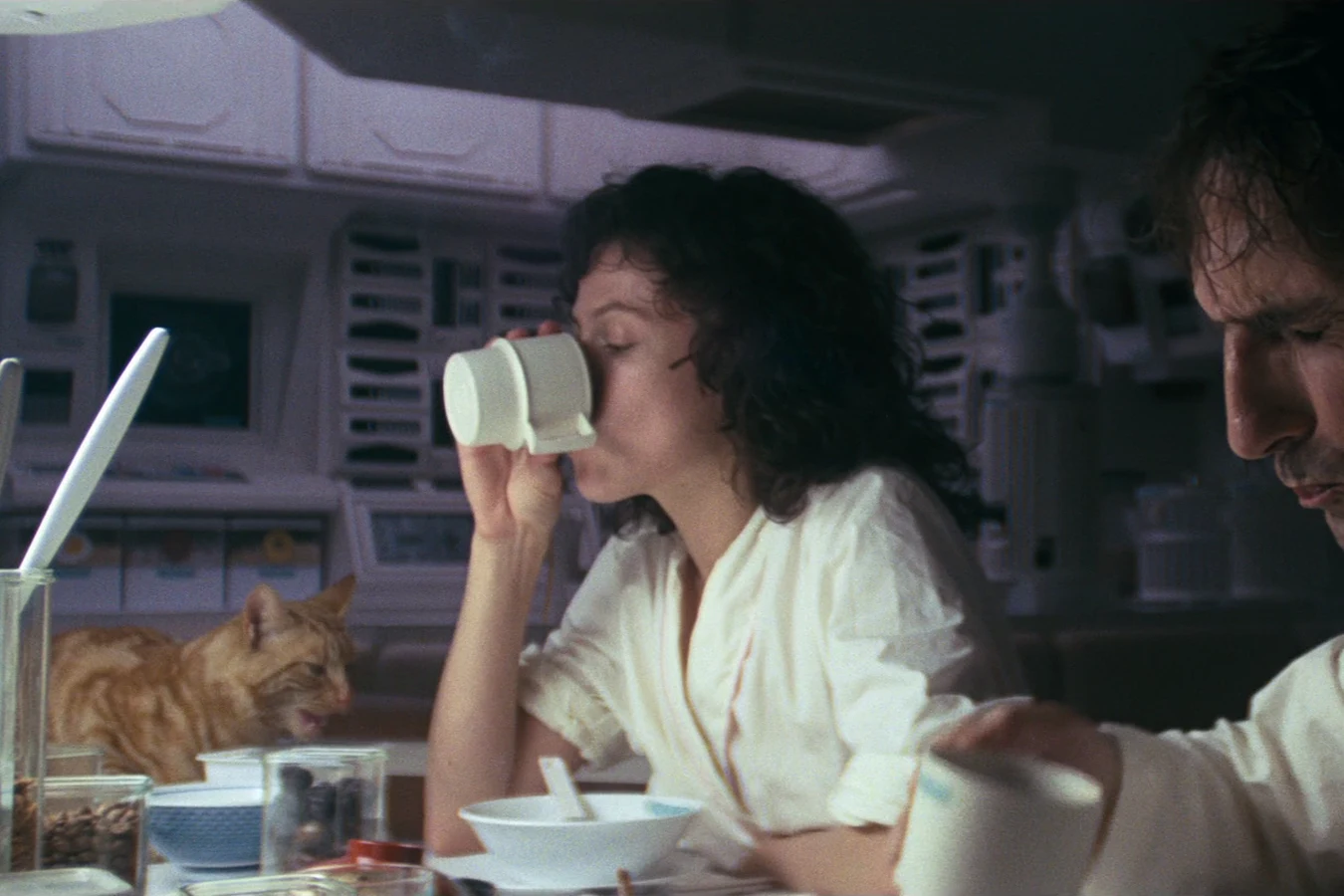 Jones eating at the Nostromo mess table while the crew has breakfast
