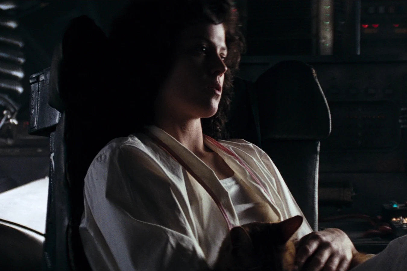 Ripley in the Narcissus pilot seat with Jones on her lap