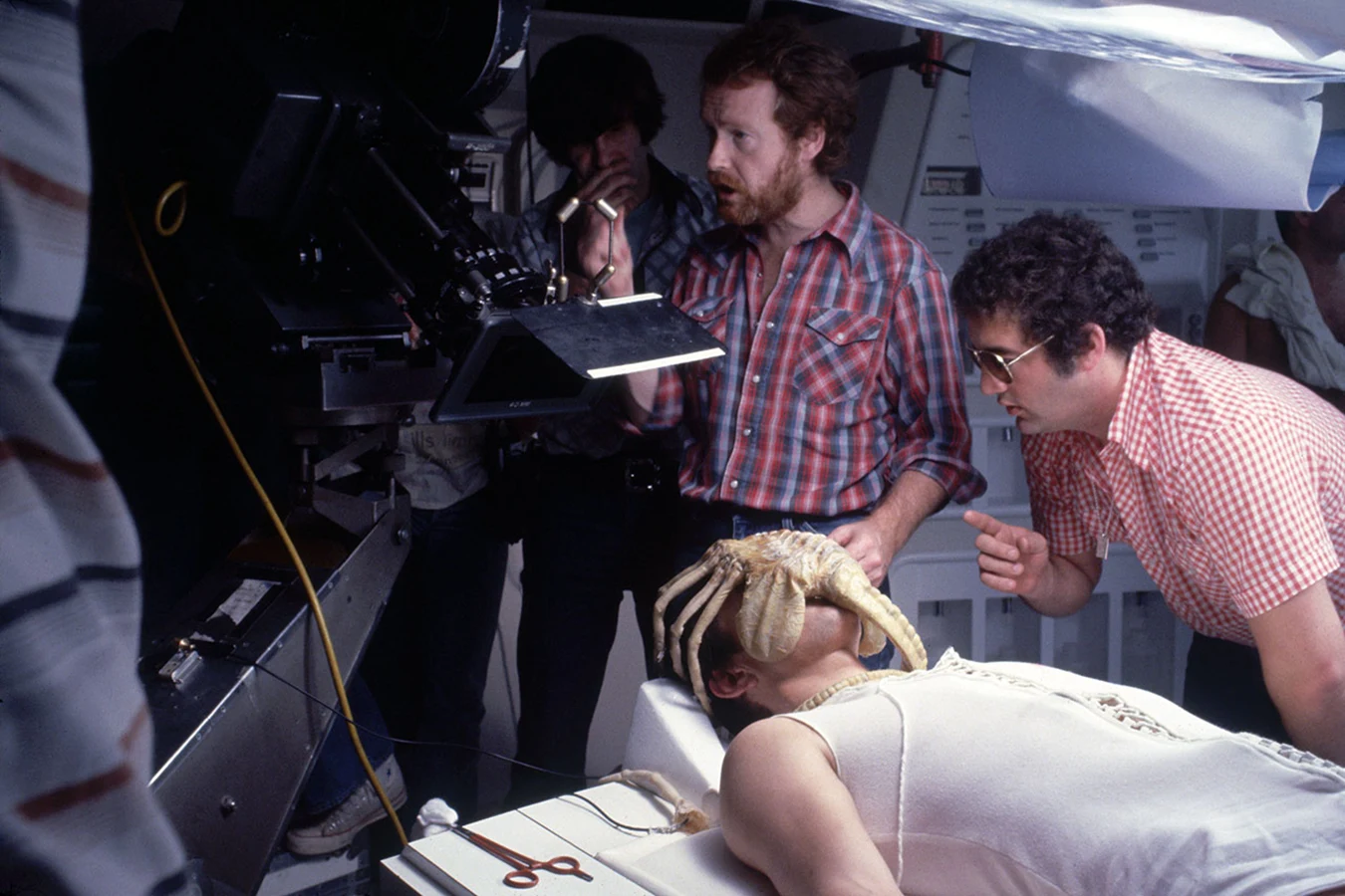Ridley Scott and the crew over John Hurt with a Facehugger on the Alien infirmary set