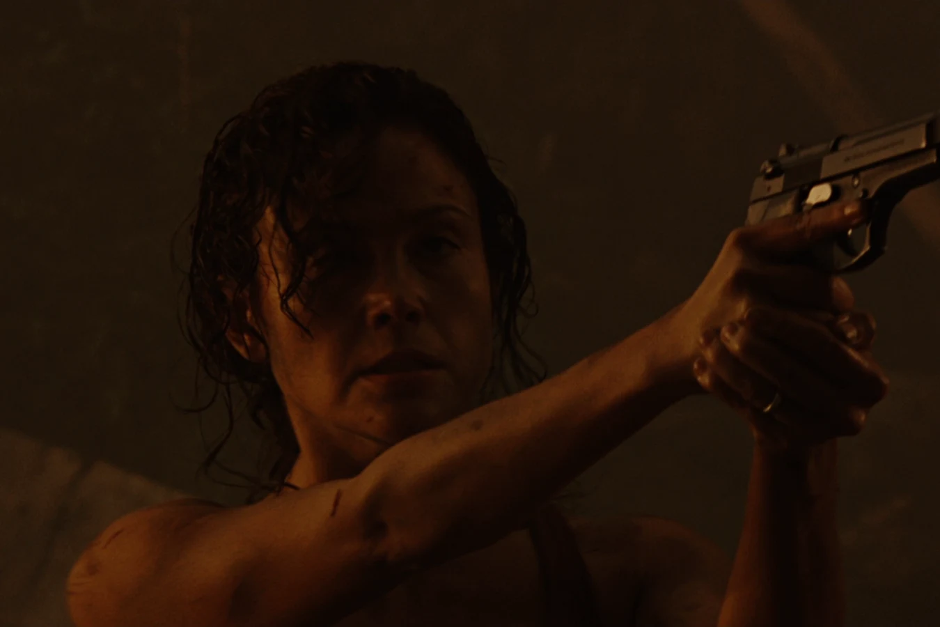 Kelly O'Brien aims a Beretta pistol during the Gunnison outbreak