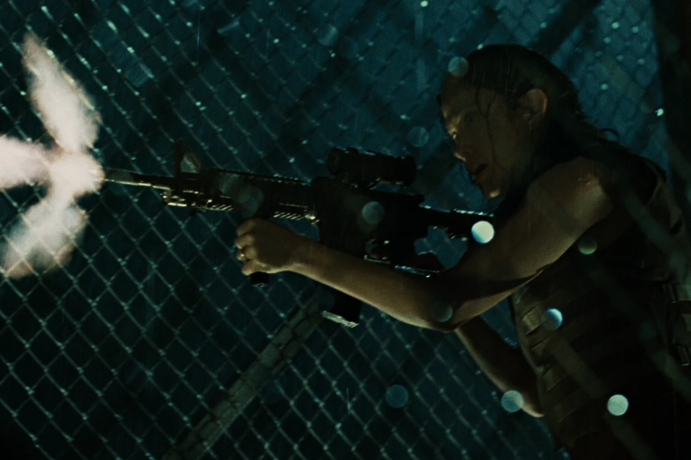 Kelly O'Brien fires an M4A1 carbine in the rain on the hospital rooftop