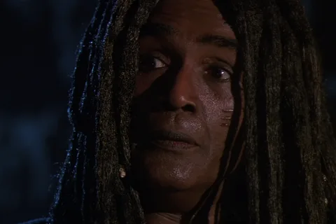 King Willie, the dreadlocked Jamaican gang leader, in a night alley in Predator 2