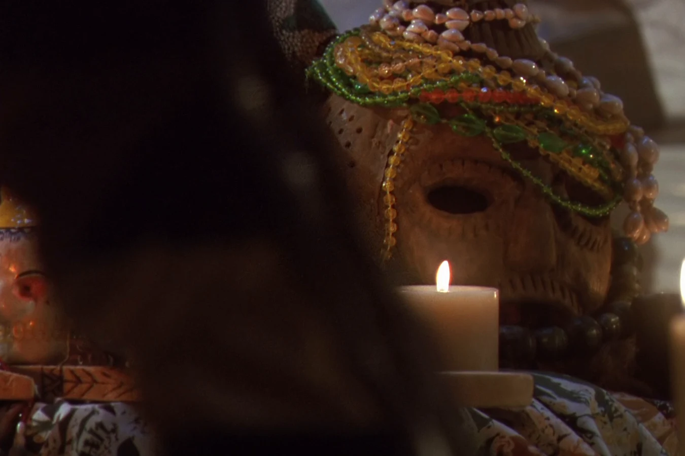 Candles and a beaded voodoo mask set up for the ritual in Ramon Vega's penthouse in Predator 2