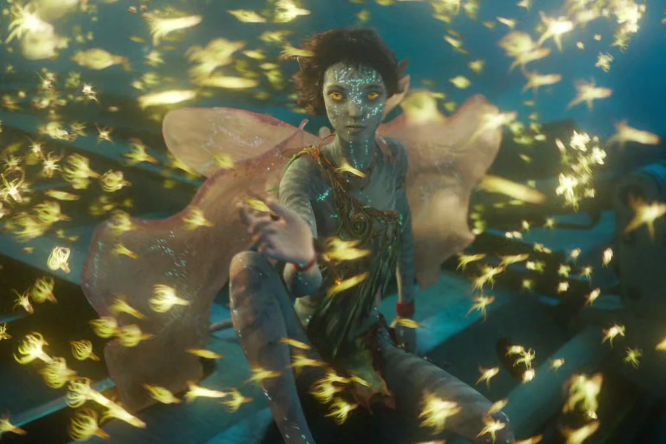 Kiri communing with bioluminescent sea life in Avatar: The Way of Water