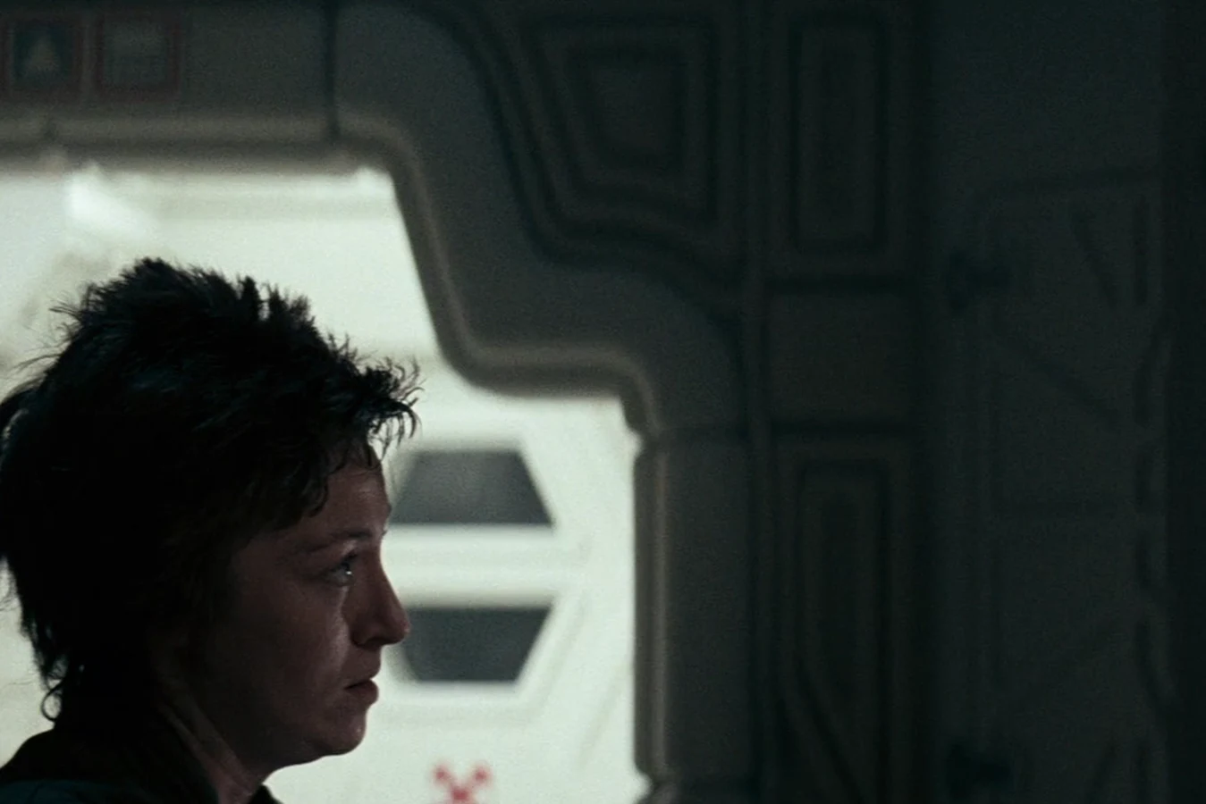 Lambert in profile beside the Nostromo schematics in Alien