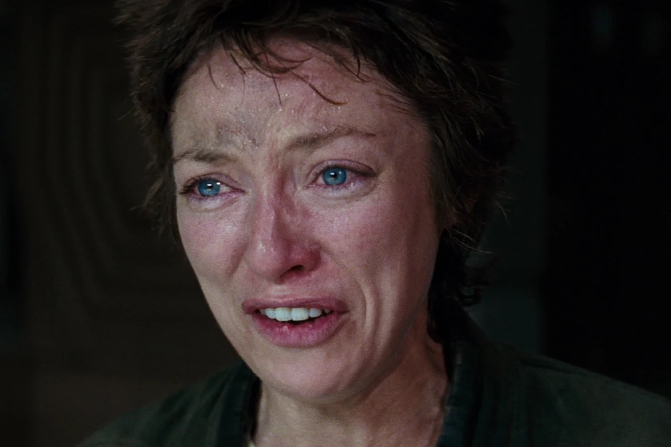 Lambert in tears, short hair damp, wearing the green jacket aboard the Nostromo in Alien
