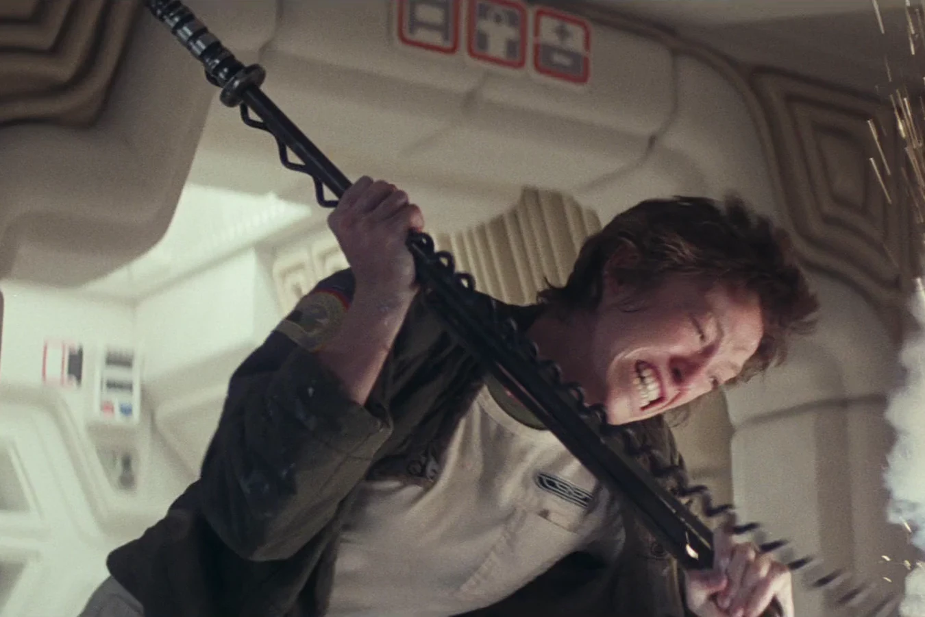 Lambert swings a cattle prod as sparks burst beside her on the Nostromo in Alien