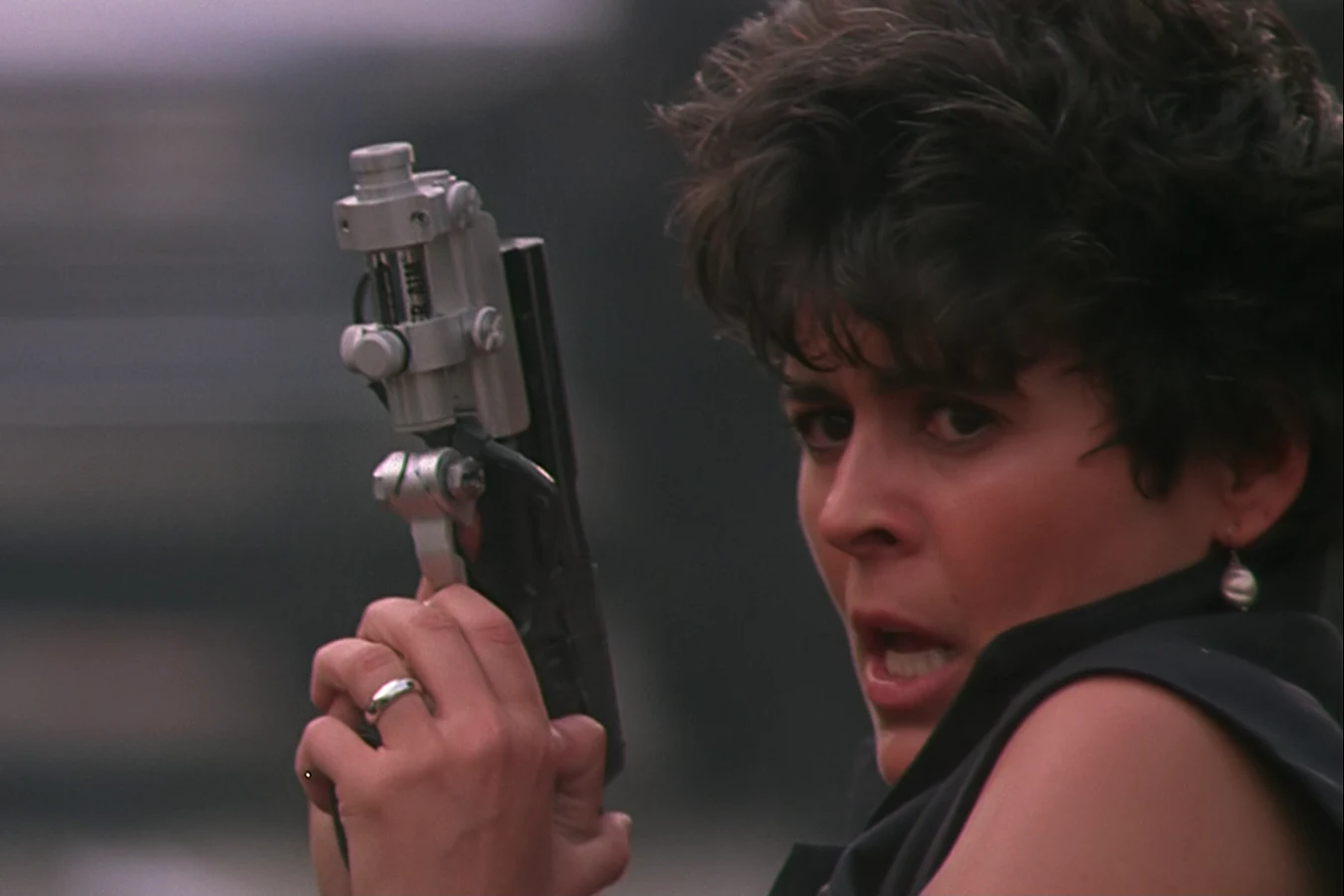 Detective Leona Cantrell aims her pistol during the Predator 2 gang war