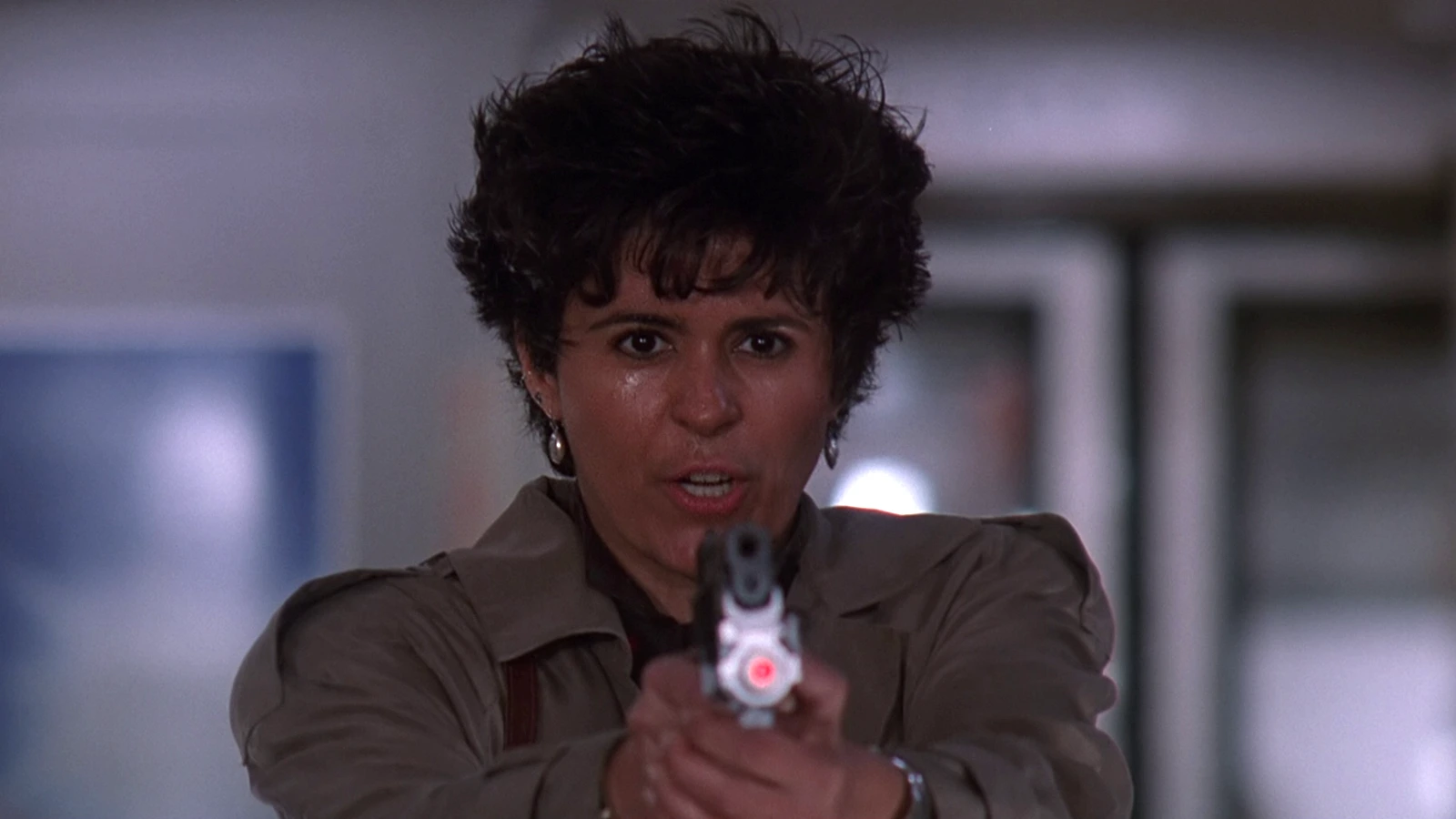 Detective Leona Cantrell in Predator 2, looking toward camera in Los Angeles heat