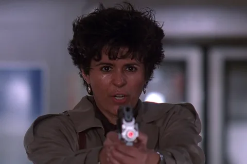 Detective Leona Cantrell in Predator 2, looking toward camera in Los Angeles heat