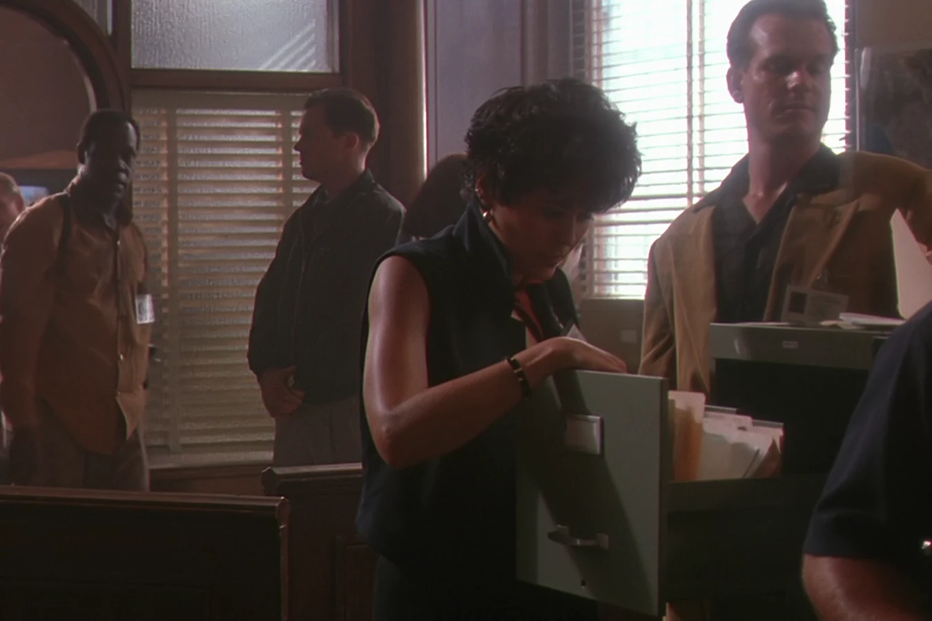 Detective Leona Cantrell at a filing cabinet in the Alvarado Precinct squadroom