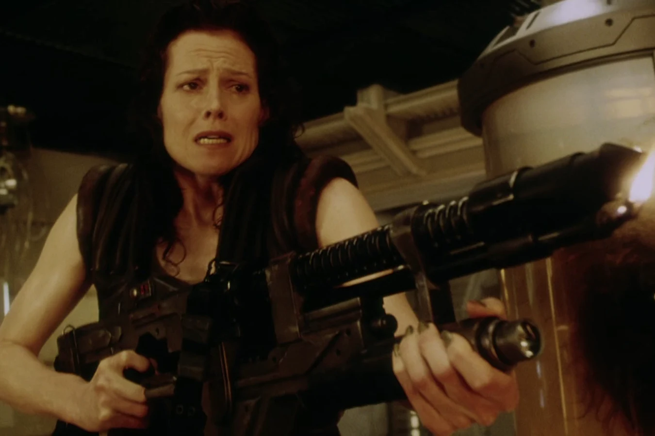 Ripley 8 holding a Draco Double Burner in the Auriga clone lab in Alien: Resurrection