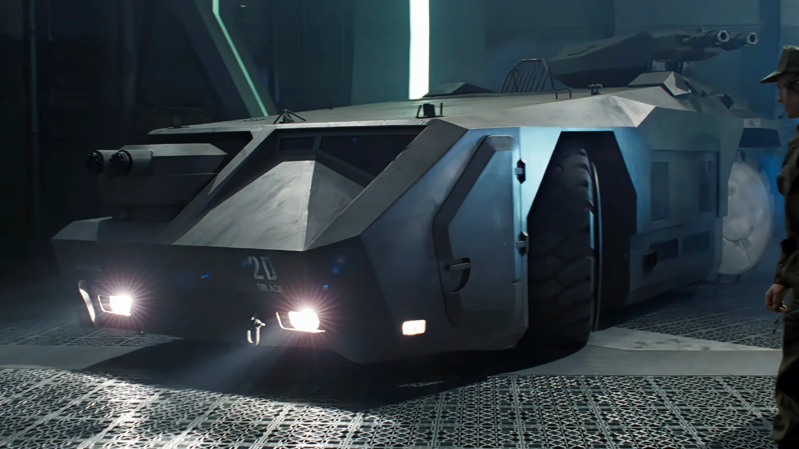 The M577 APC parked in the Sulaco hangar in Aliens, marked 2D, with headlights on and the roof turret stowed