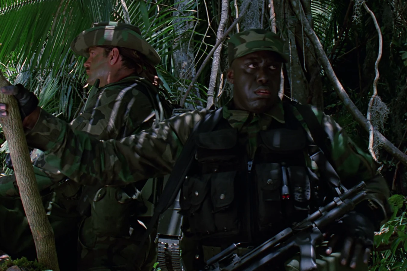 Mac Eliot walking the jungle trail beside Blain Cooper in Predator