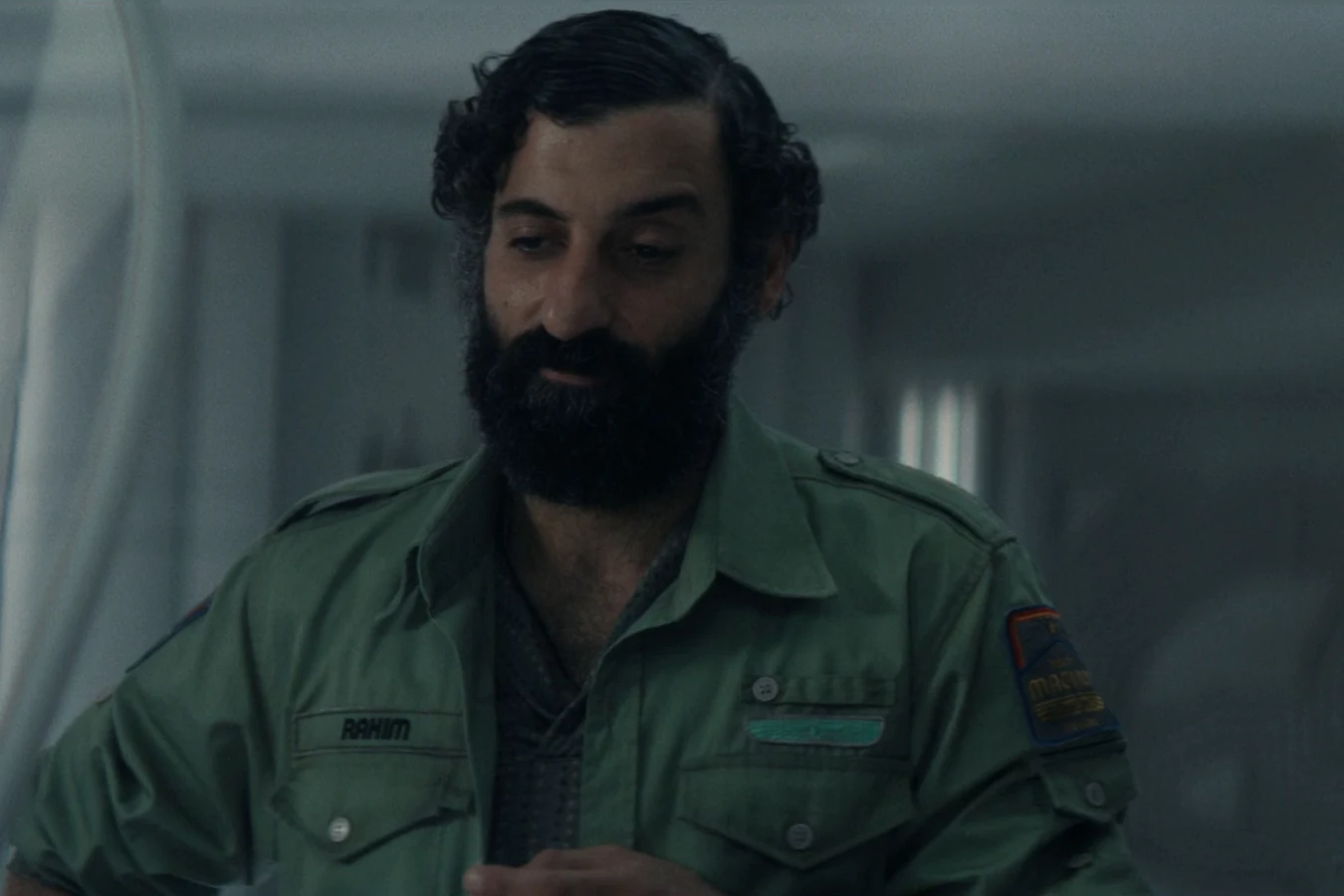 Rahim, the Maginot doctor, in his green uniform in the medbay in Alien: Earth