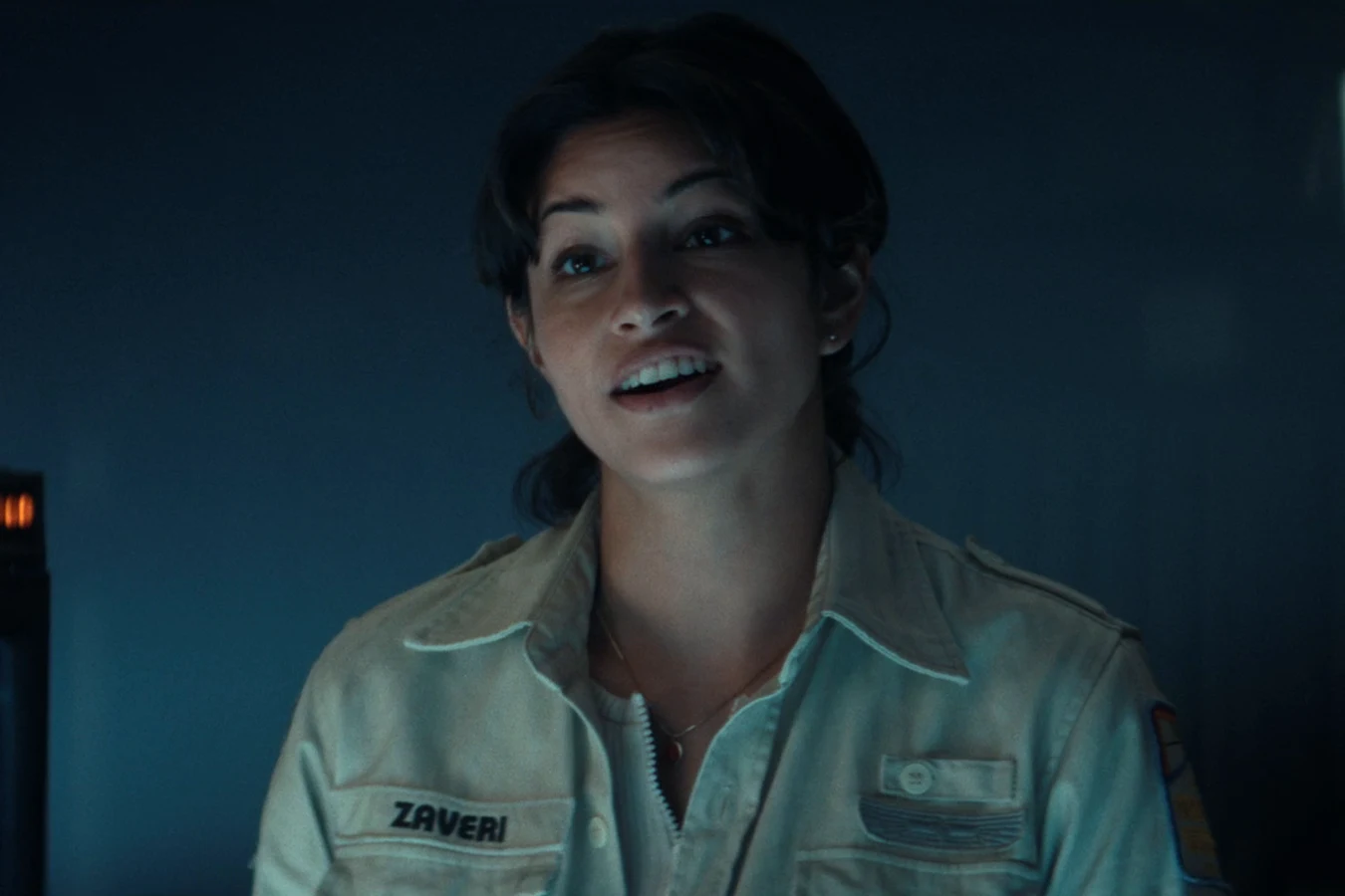 Zoya Zaveri in her Maginot uniform with a ZAVERI name tape, speaking beside a navigation screen in Alien: Earth