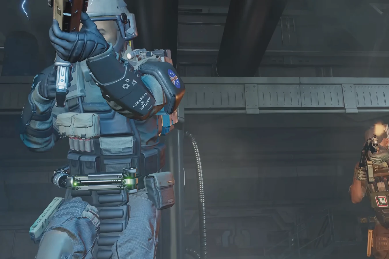 Two Colonial Marines in combat, one wearing a glowing green medic kit on his belt
