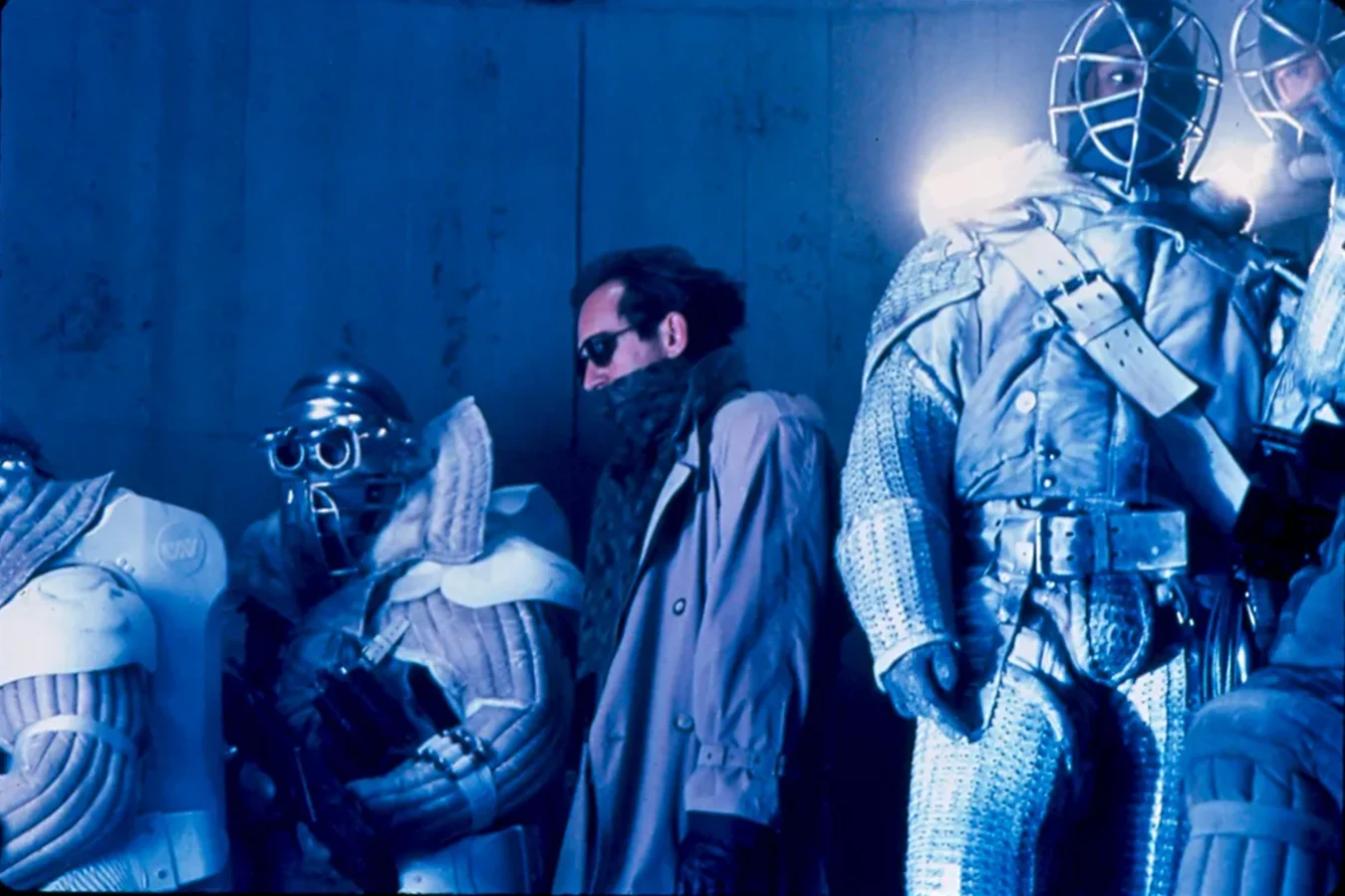 Lance Henriksen as Michael Bishop on the Alien 3 set, standing between company troops in sealed suits