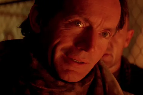 Michael Bishop speaking to Ellen Ripley through a fence on Fury 161 in Alien 3