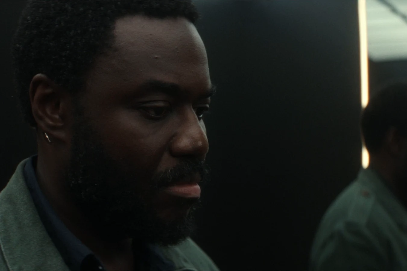 Morrow riding an elevator beside Kirsh after the arbitration hearing in Alien: Earth