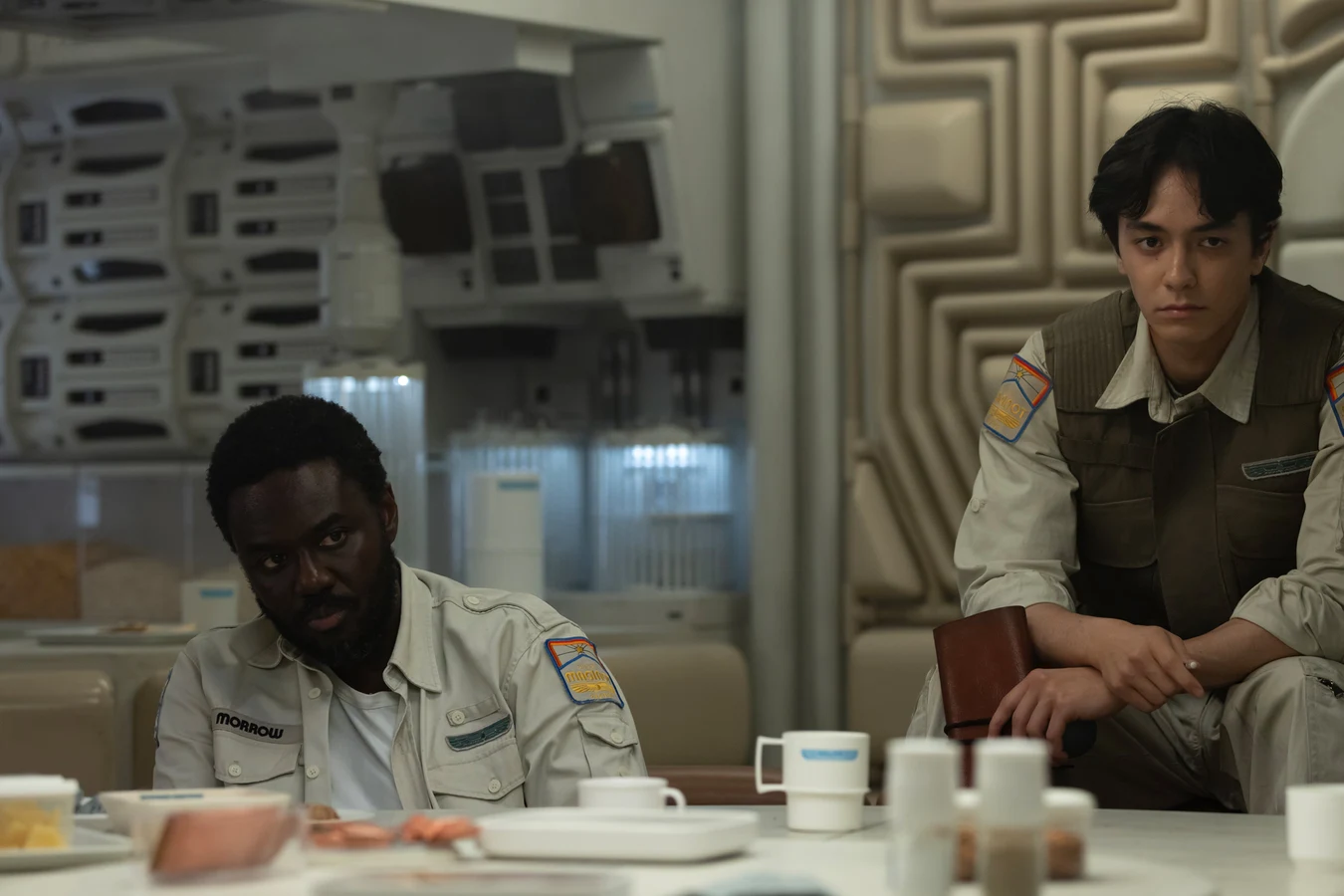Morrow seated at the Maginot mess table with executive officer Zoya Zaveri in Alien: Earth