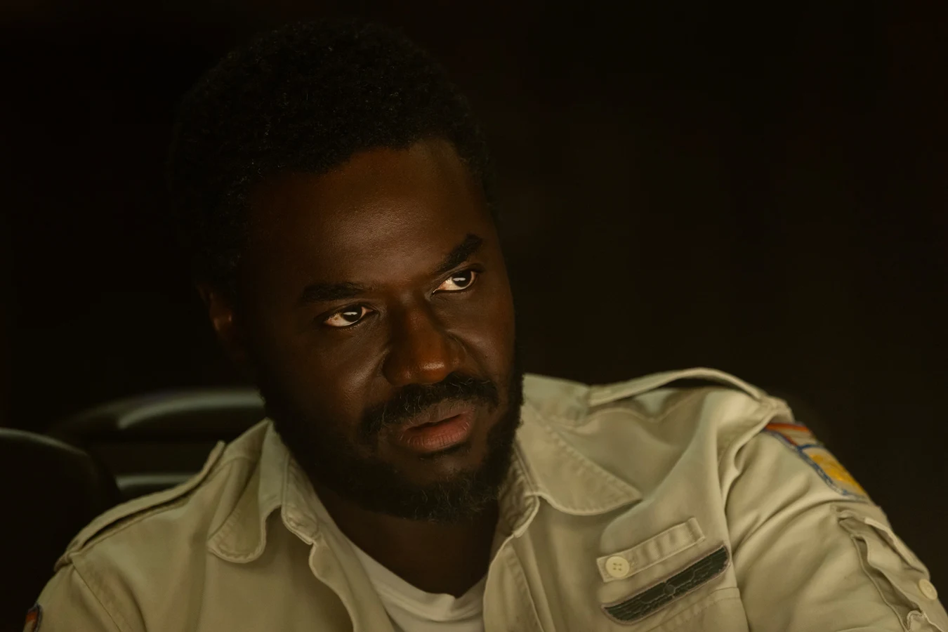 Morrow in his Weyland-Yutani security uniform at the Maginot mess table in Alien: Earth