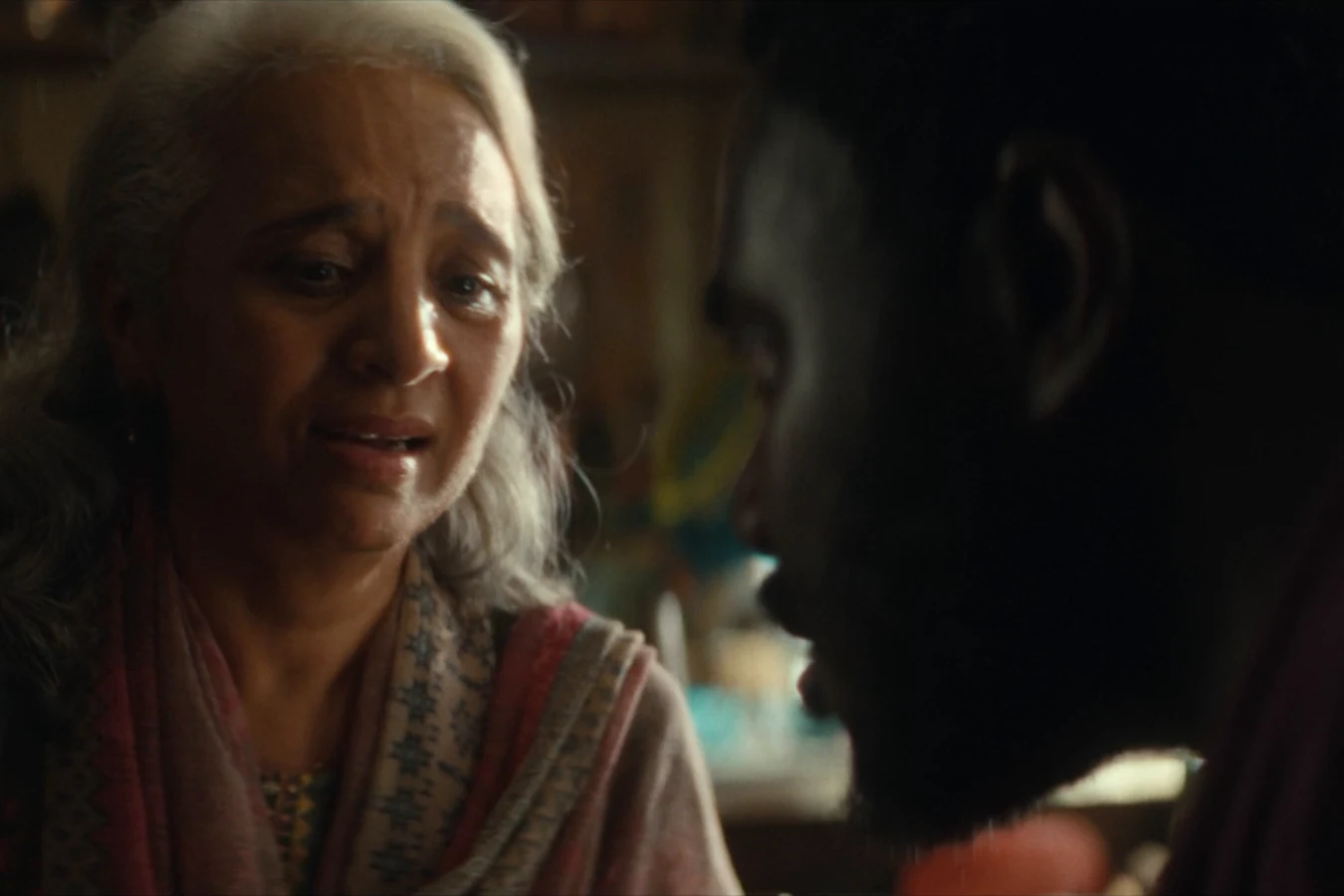 Slightly's mother speaking with Morrow in the shadows of her home in Alien: Earth