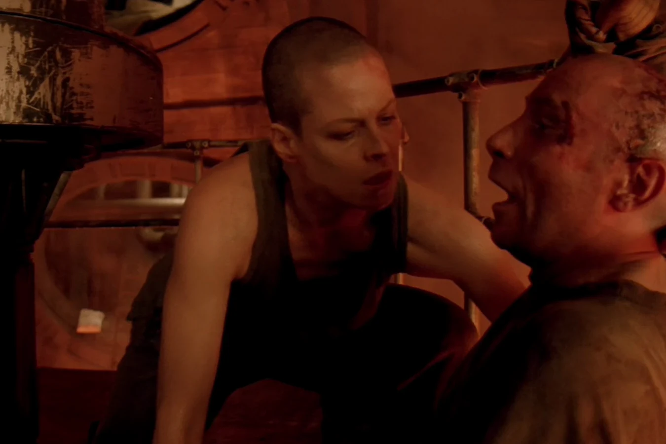 Ripley leaning over Morse in the leadworks crane after the pour in Alien 3