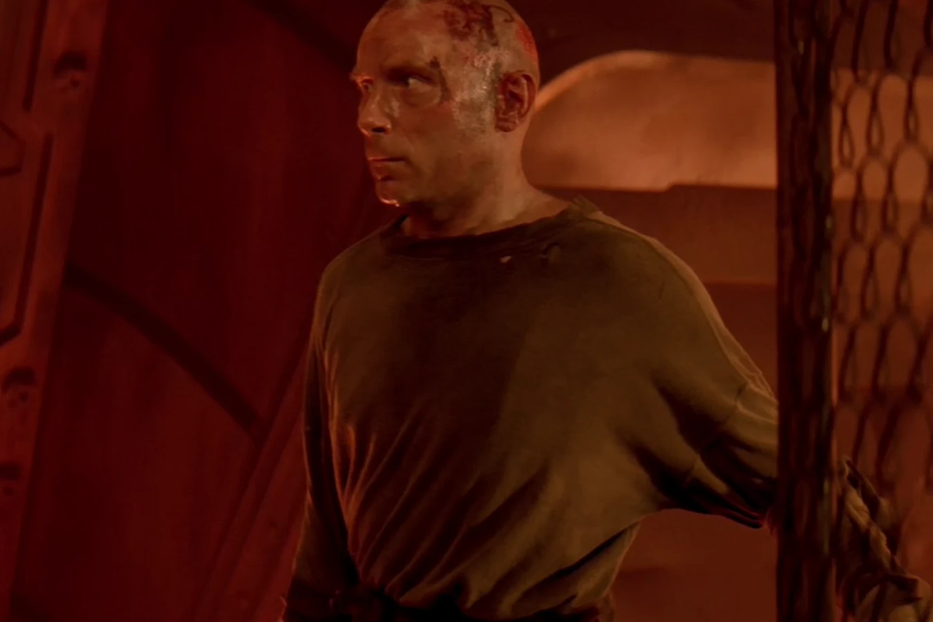 Morse standing by a wire fence in the Fiorina 161 infirmary in Alien 3