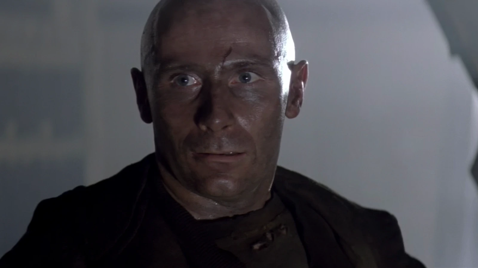 Morse staring ahead in a dark prison coat in Alien 3