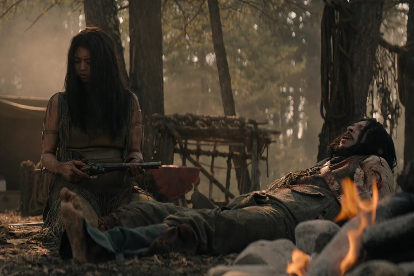 Naru holds Raphael Adolini's flintlock beside the wounded translator in Prey