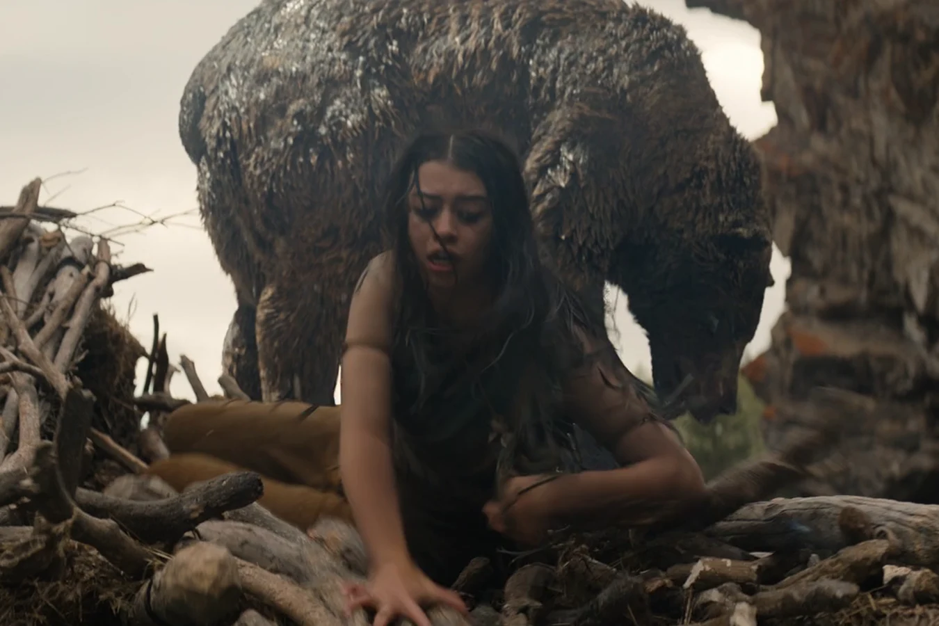 Naru crawls through fallen timber as a grizzly bear closes on her in Prey