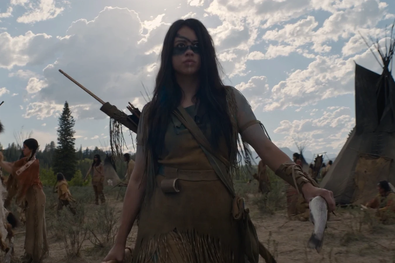 Naru carries a fish through her Comanche camp in Prey