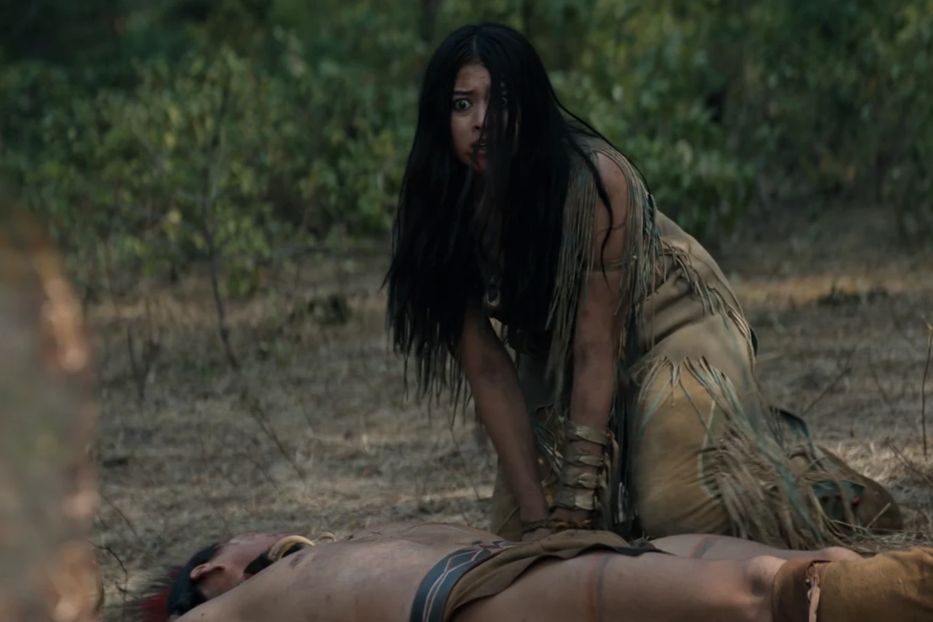 Naru finds a fallen Comanche warrior after the Feral Predator's attack in Prey
