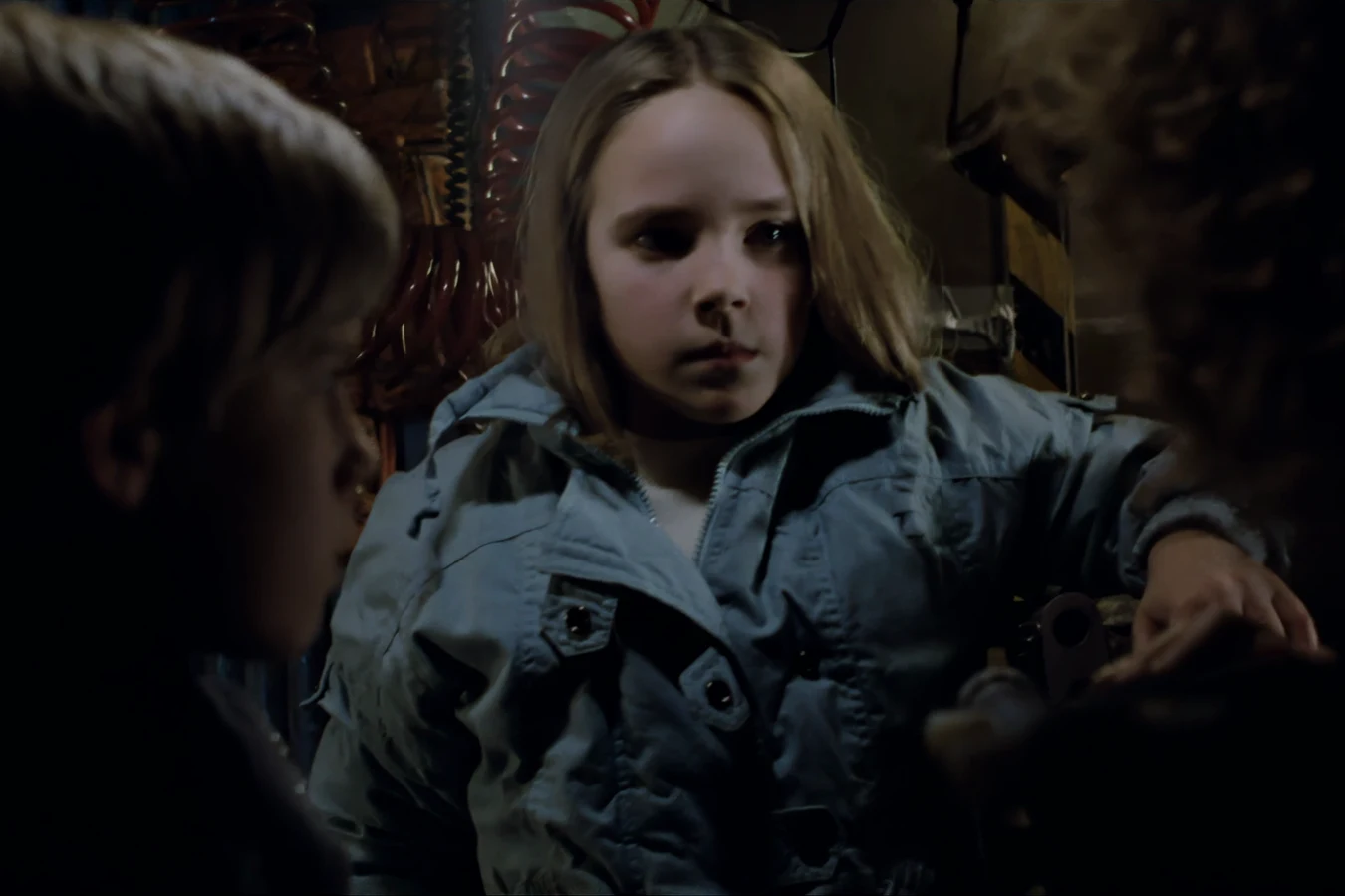 Newt in a blue jacket between Tim and Anne Jorden in the family rover