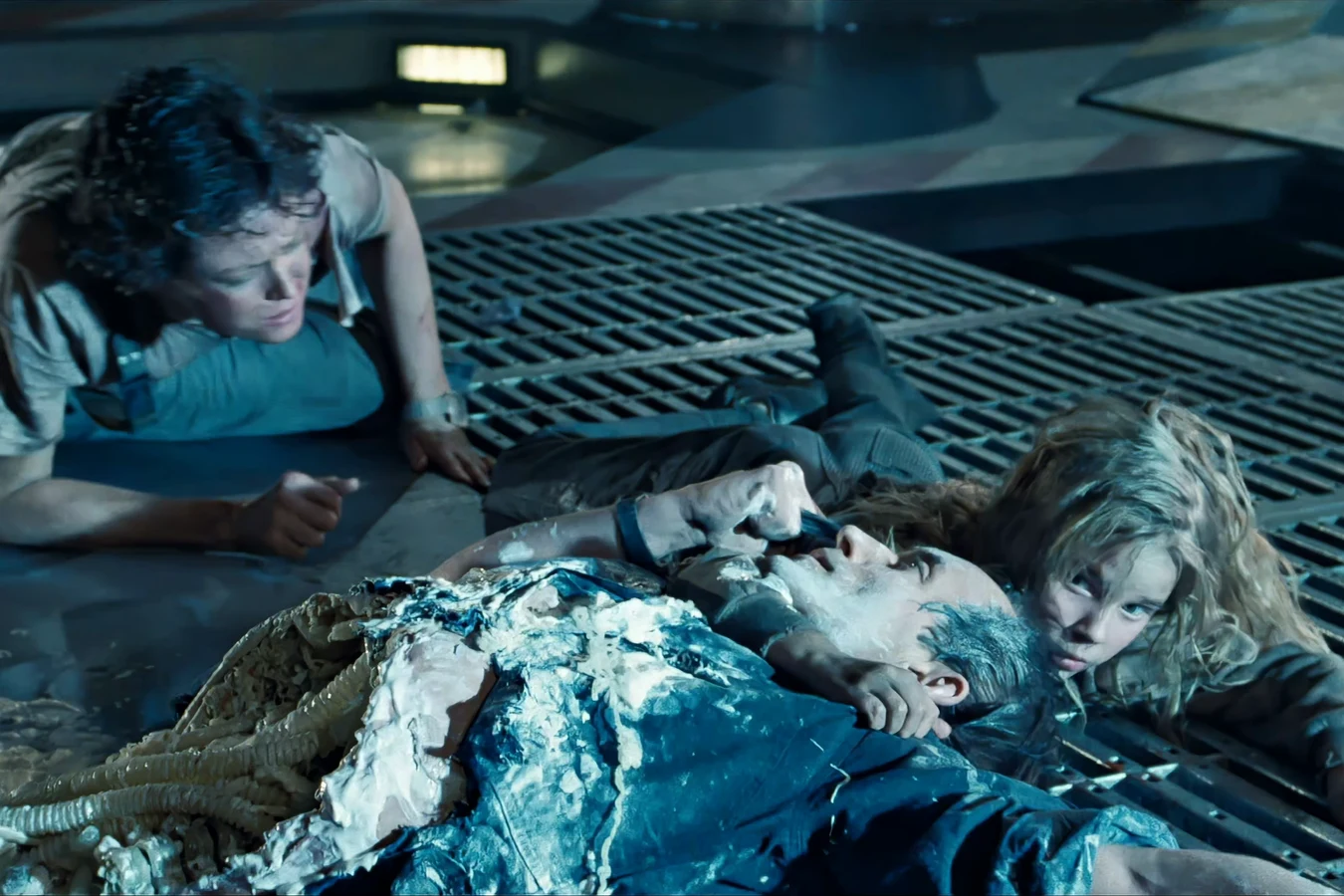 Newt beside damaged Bishop on the Sulaco deck while Ripley looks on in Aliens