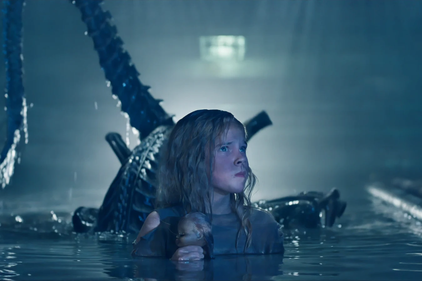Newt standing waist-deep in flooded colony sublevels with Casey as a Xenomorph looms behind her in Aliens