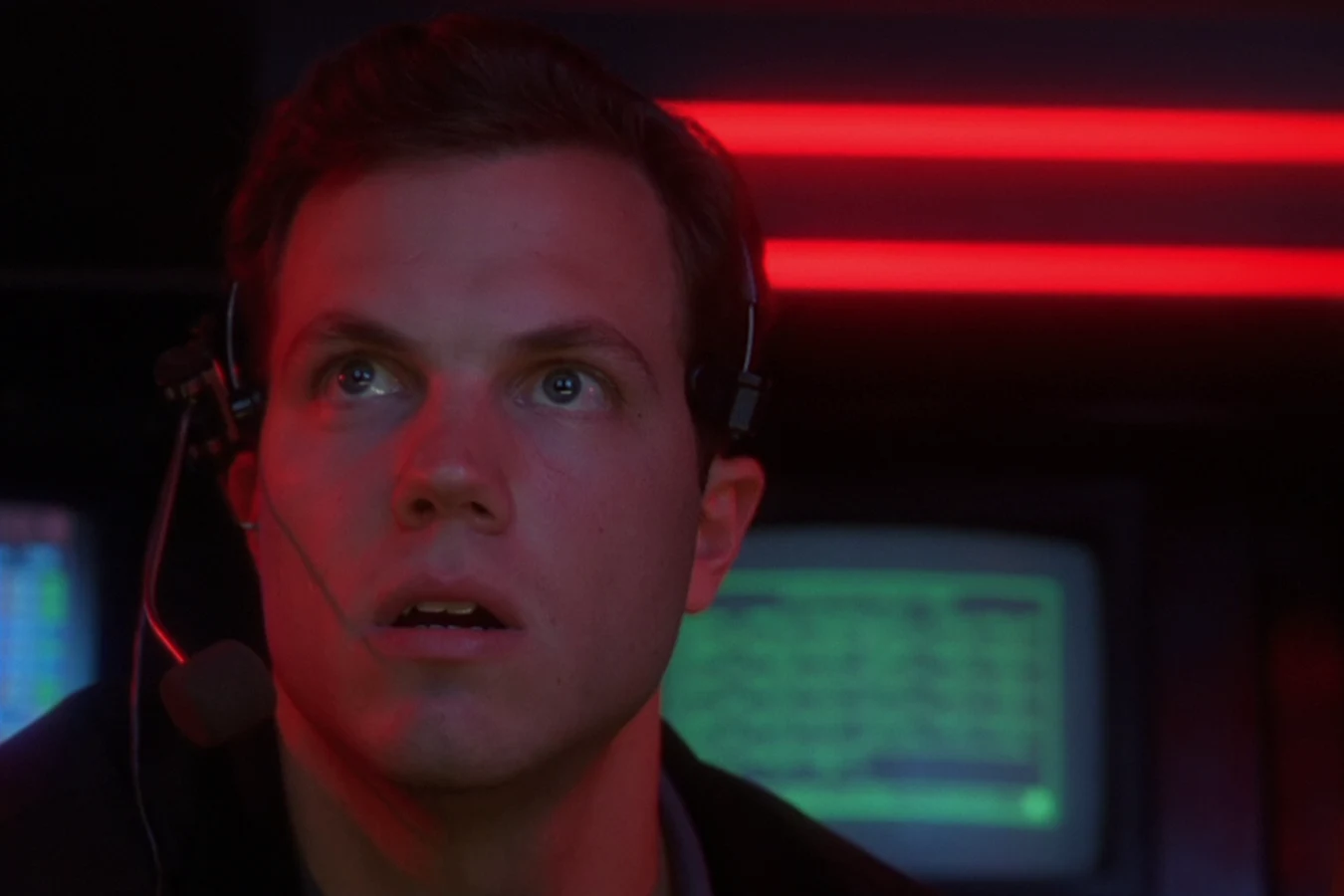 Garber on a headset in the OWLF trailer in Predator 2