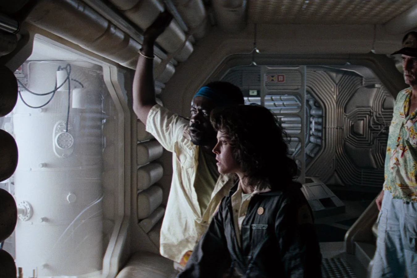Parker at a Nostromo viewport with Ripley, Brett, and Lambert in Alien