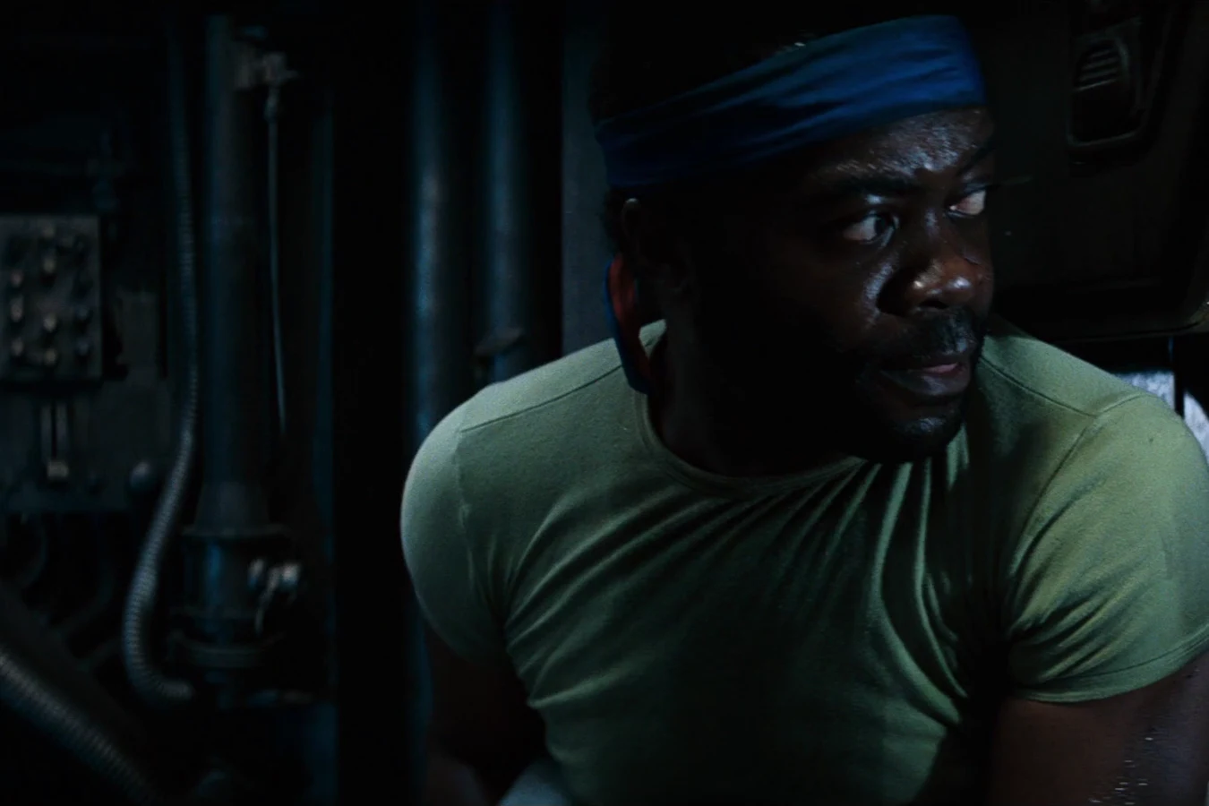Parker in a green shirt and blue headband in the Nostromo engineering spaces