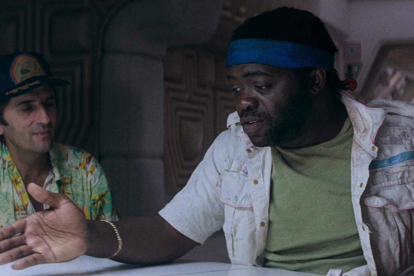 Parker talks to Brett across the mess table during the bonus argument in Alien