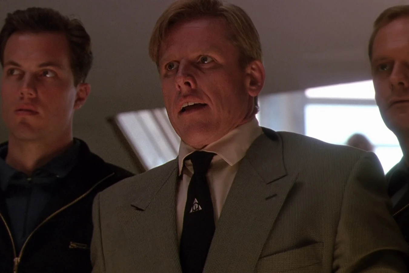 Peter Keyes stands with Garber and another OWLF agent in Predator 2