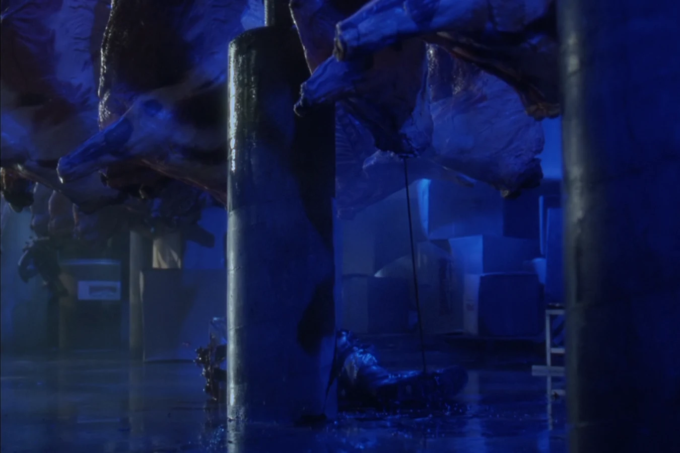 Peter Keyes's body lies on the slaughterhouse floor after a smart disc cut him in half in Predator 2