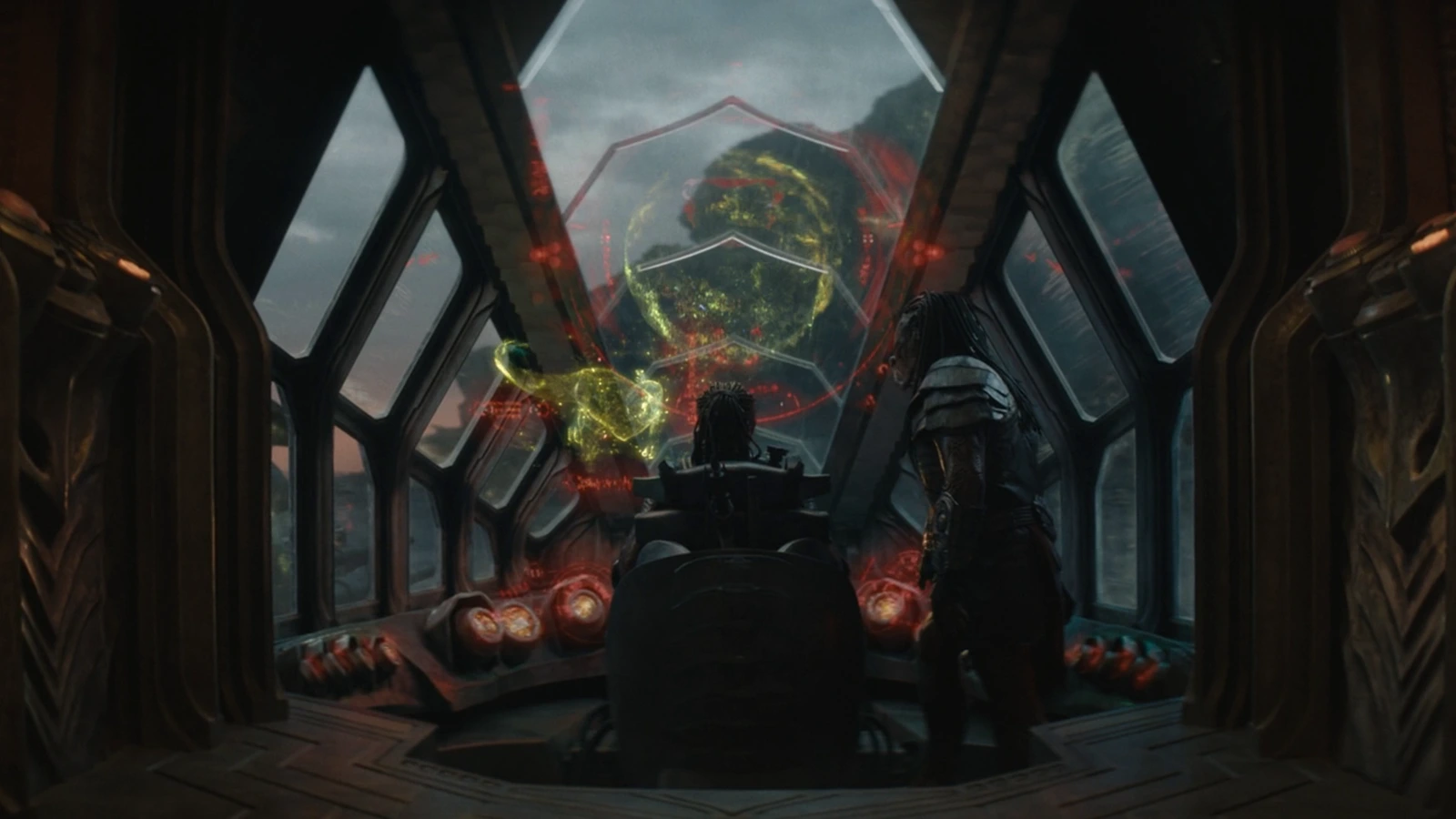 Dek and Kwei looking at holograms of different planets on Kwei's ship from Predator: Badlands