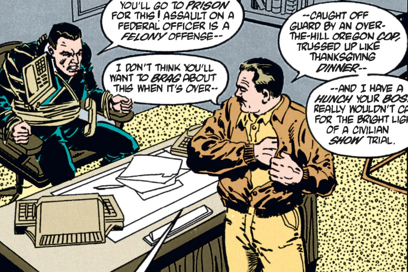 Smithers tied to his office chair as Rasche stands over him in the Predator: Cold War comic