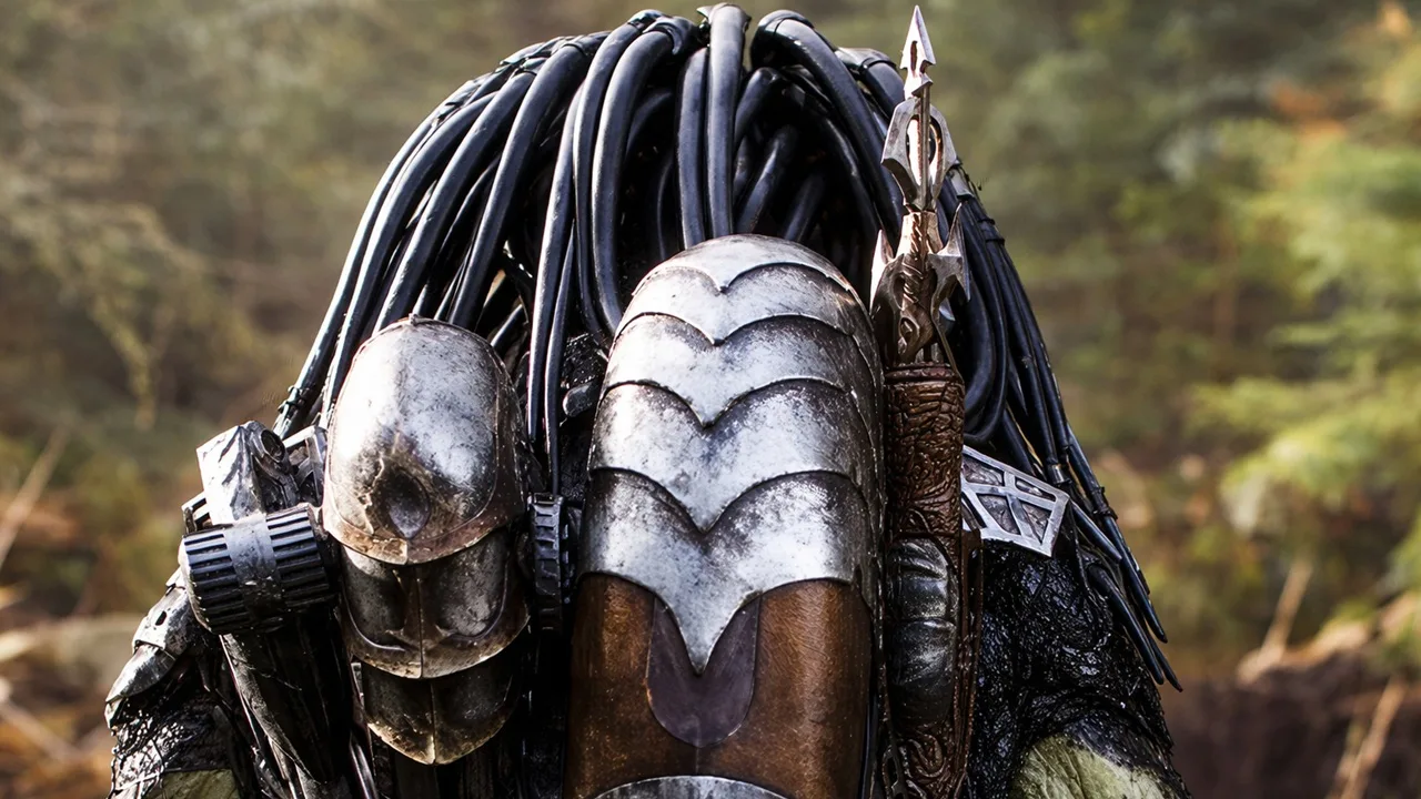 Wolf Predator seen from behind, showing his armor, bio-mask, and spear in a forest
