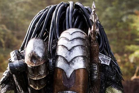 Wolf Predator seen from behind, showing his armor, bio-mask, and spear in a forest